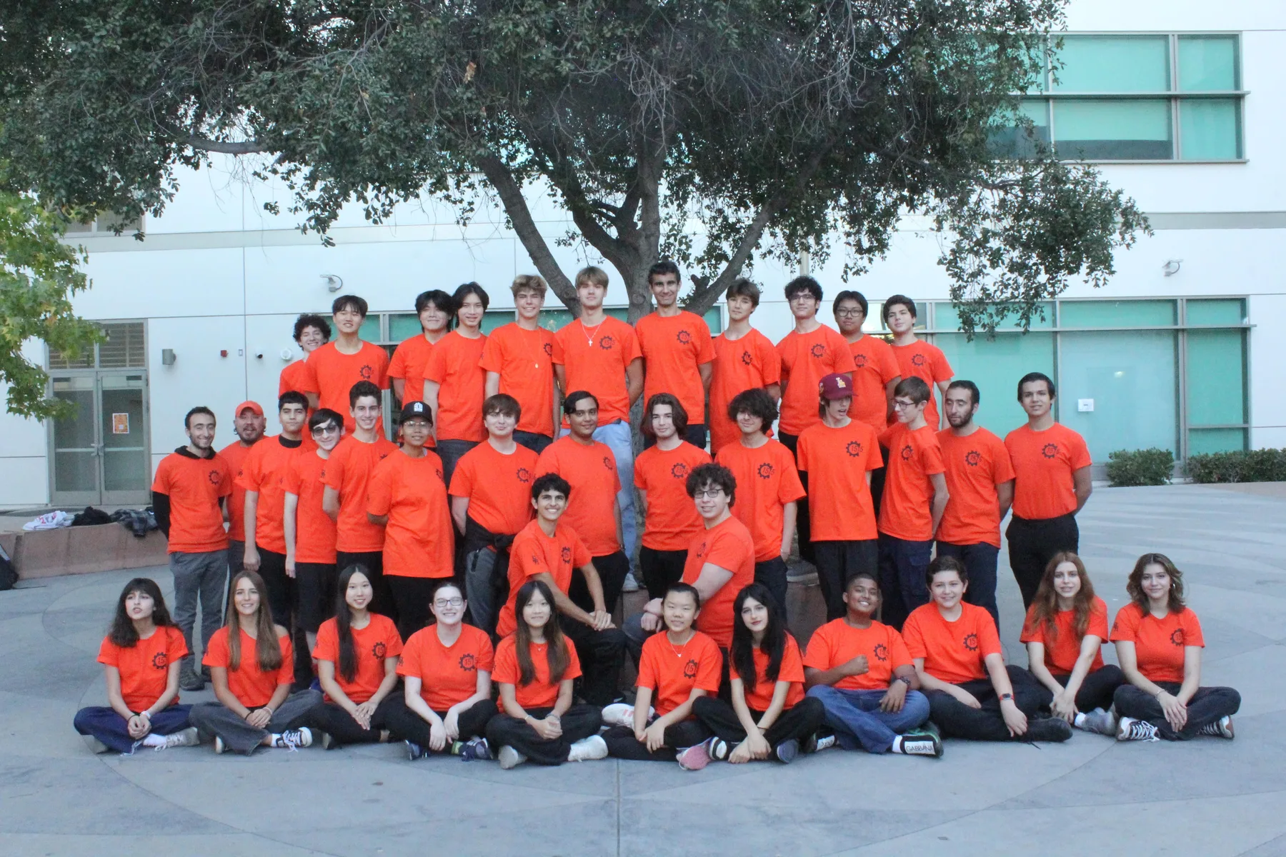MorTorq team members wearing orange team shirts outside Beverly Hills High School in 2023